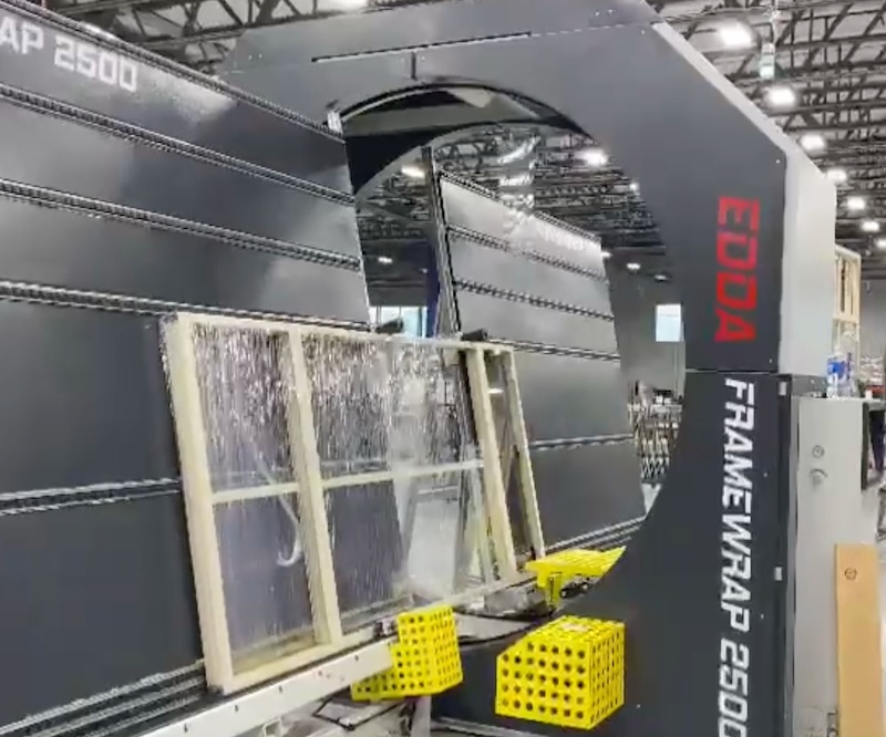Edda Framewrap 250 S performing automated orbital wrapping on a window frame in an industrial facility.